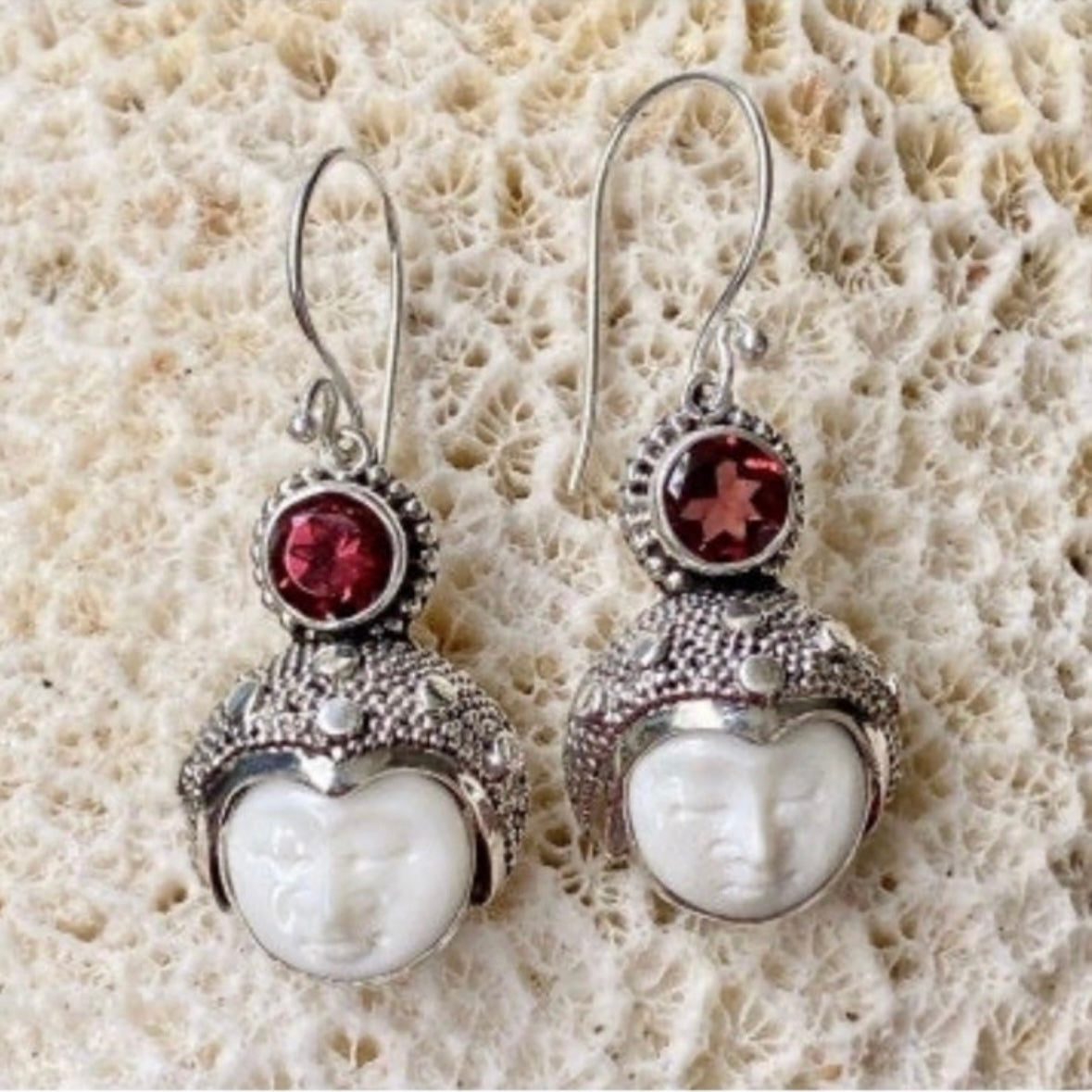 Hand-crafted 925 sterling silver Balinese carved bone face earrings with faceted/cut Garnet gemstones