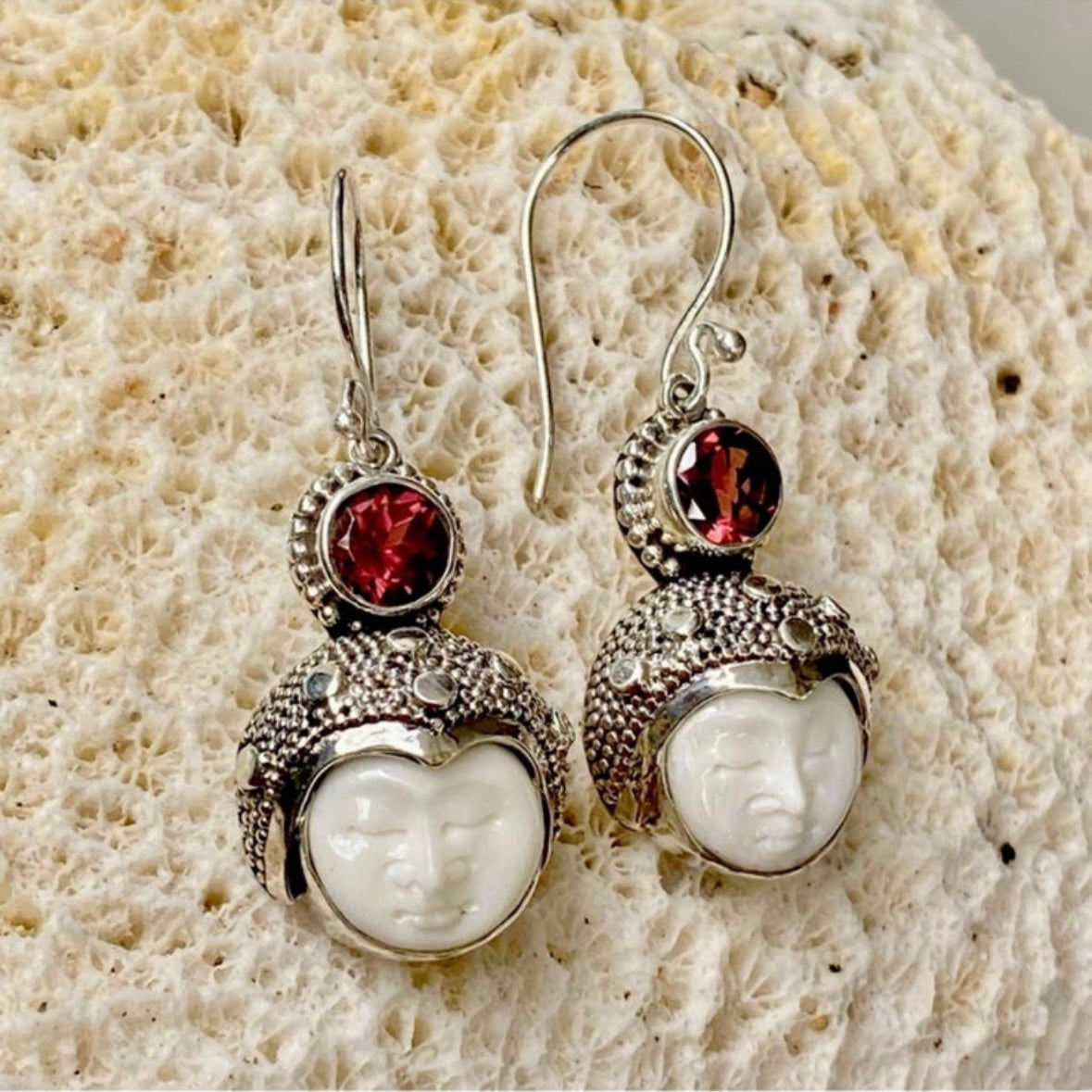 Hand-crafted 925 sterling silver Balinese carved bone face earrings with faceted/cut Garnet gemstones
