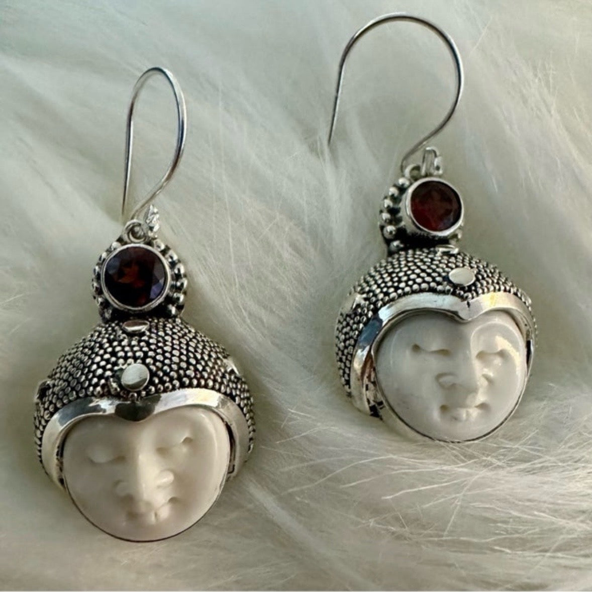 Hand-crafted 925 sterling silver Balinese carved bone face earrings with faceted/cut Garnet gemstones